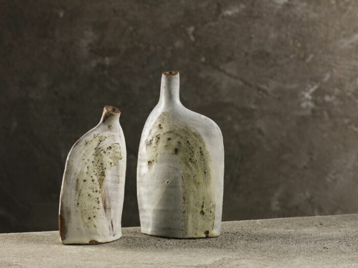 Bottles decorated with wild clay slips and glazes